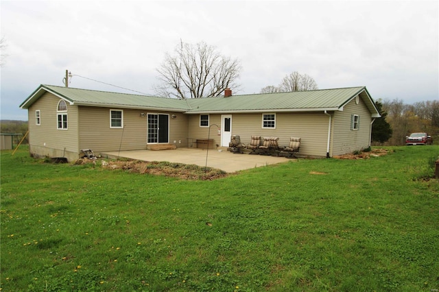 634 Ccam Rose Ln, Perryville, MO 63775 - rear view of house featuring a patio, a yard, metal roof, and a chimney