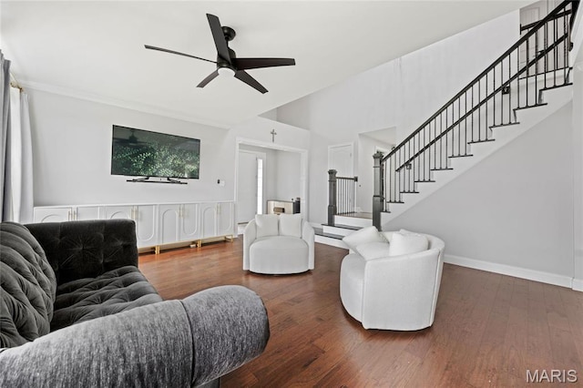 351 Oak Stand Ct, Chesterfield, MO 63005 - living room with stairway, dark wood-style flooring, a ceiling fan, baseboards, and a high ceiling