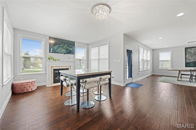 351 Oak Stand Ct, Chesterfield, MO 63005 - dining room with baseboards, a fireplace with flush hearth, a chandelier, dark wood-style flooring, and recessed lighting