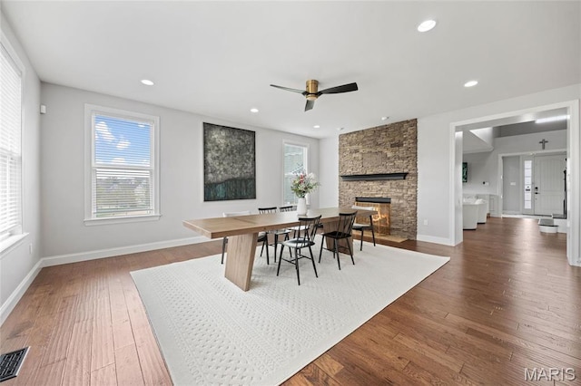 351 Oak Stand Ct, Chesterfield, MO 63005 - dining space featuring ceiling fan, dark wood-style flooring, a stone fireplace, baseboards, and recessed lighting