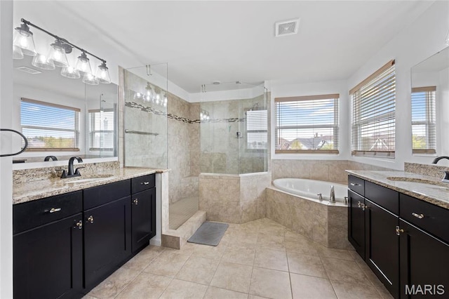 351 Oak Stand Ct, Chesterfield, MO 63005 - bathroom featuring healthy amount of natural light, tiled shower, and a bath