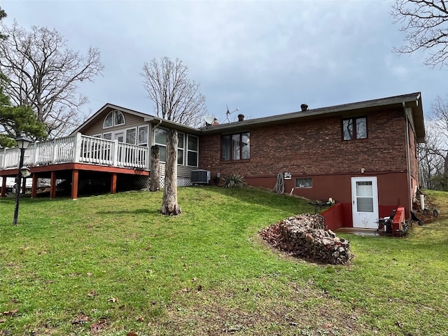 515 Rue Lamande, Bonne Terre, MO 63628 - rear view of property with a wooden deck, brick siding, a lawn, a sunroom, and central AC