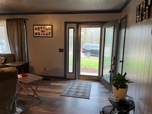 515 Rue Lamande, Bonne Terre, MO 63628 - foyer entrance with ornamental molding, a textured ceiling, dark wood finished floors, wooden walls, and baseboards