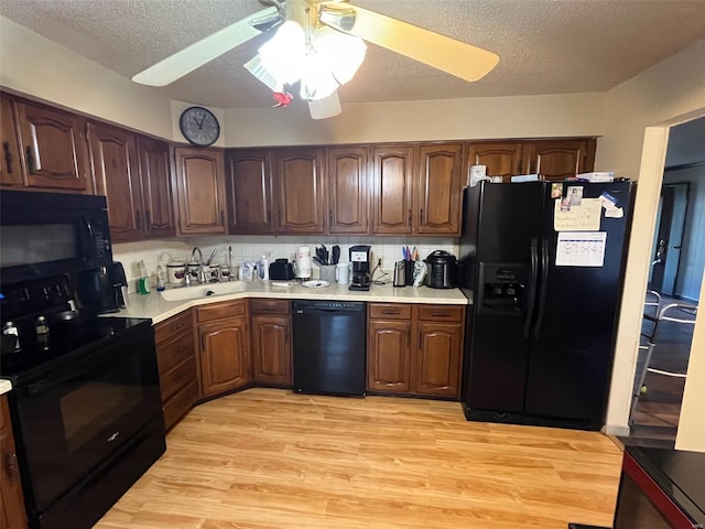 515 Rue Lamande, Bonne Terre, MO 63628 - kitchen with black appliances, light countertops, light wood finished floors, a textured ceiling, and a ceiling fan