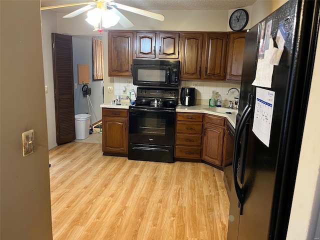515 Rue Lamande, Bonne Terre, MO 63628 - kitchen with black appliances, light countertops, a sink, and decorative backsplash