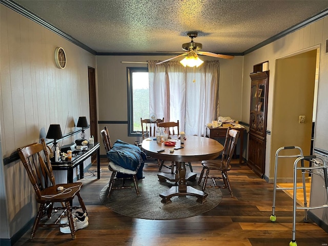 515 Rue Lamande, Bonne Terre, MO 63628 - dining space with crown molding, ceiling fan, dark wood-style flooring, a textured ceiling, and wooden walls