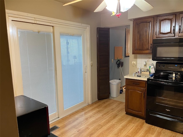 515 Rue Lamande, Bonne Terre, MO 63628 - kitchen featuring black appliances, light countertops, light wood-type flooring, a ceiling fan, and tasteful backsplash