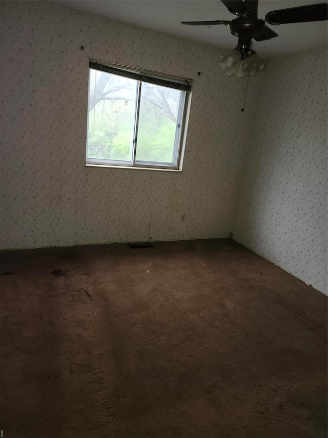 6081 Silver Fox Dr, Florissant, MO 63034 - spare room featuring carpet flooring, wallpapered walls, and a ceiling fan
