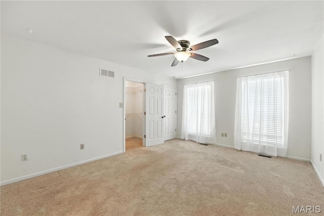 1827 Pheasant Run Dr, Maryland Heights, MO 63043 - unfurnished bedroom with light carpet, ceiling fan, and a walk in closet