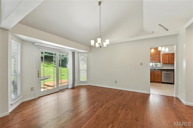 1827 Pheasant Run Dr, Maryland Heights, MO 63043 - empty room with a chandelier, light wood finished floors, plenty of natural light, and vaulted ceiling