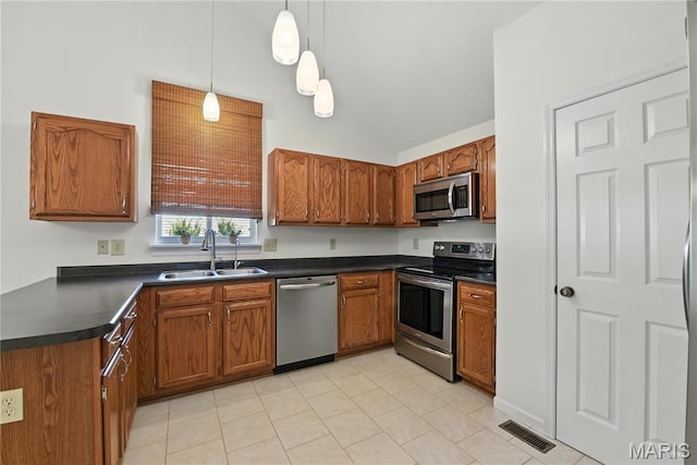 1827 Pheasant Run Dr, Maryland Heights, MO 63043 - kitchen with appliances with stainless steel finishes, dark countertops, brown cabinets, pendant lighting, and high vaulted ceiling