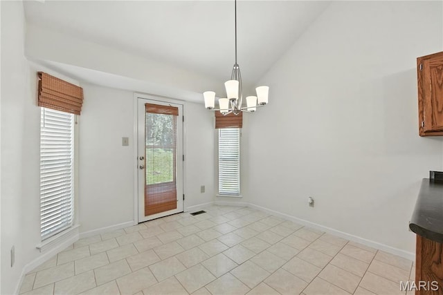 1827 Pheasant Run Dr, Maryland Heights, MO 63043 - unfurnished dining area with a chandelier, lofted ceiling, and light tile patterned floors