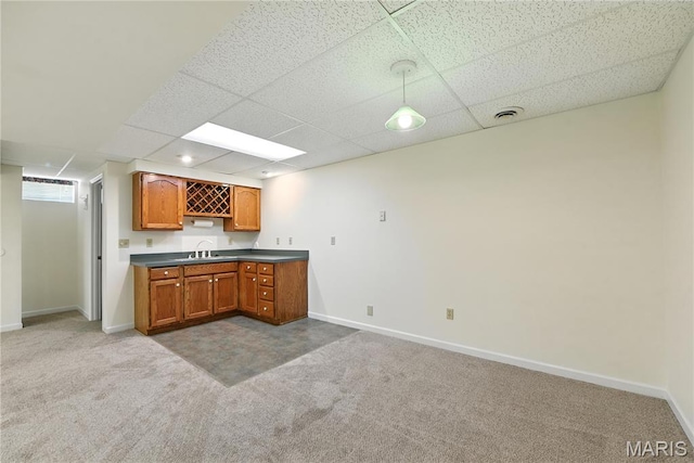 1827 Pheasant Run Dr, Maryland Heights, MO 63043 - kitchen with carpet flooring, dark countertops, a drop ceiling, and brown cabinets