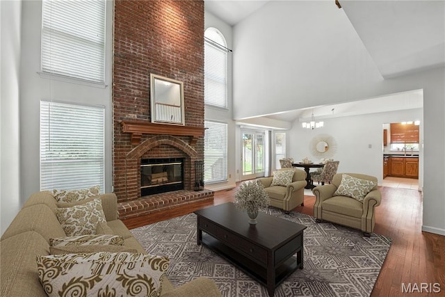 1827 Pheasant Run Dr, Maryland Heights, MO 63043 - living area featuring high vaulted ceiling, wood finished floors, and a fireplace