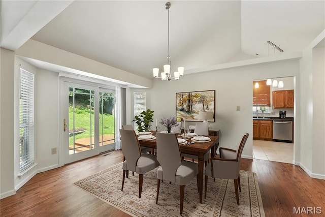 1827 Pheasant Run Dr, Maryland Heights, MO 63043 - dining room with a chandelier, plenty of natural light, light wood-style flooring, and lofted ceiling