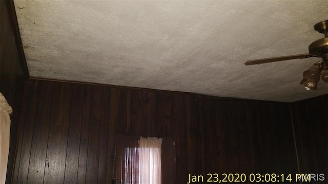 206 N 11th St, Coulterville, IL 62237 - detailed view of wooden walls, a ceiling fan, and a textured ceiling