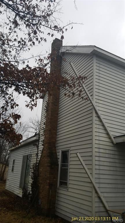 206 N 11th St, Coulterville, IL 62237 - view of side of home featuring a chimney