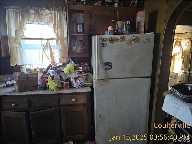206 N 11th St, Coulterville, IL 62237 - kitchen with freestanding refrigerator, arched walkways, and light countertops