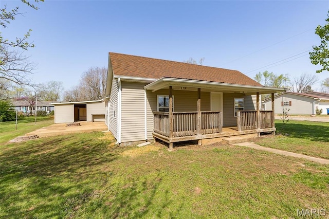 209 N Washington St, Desloge, MO 63601 - view of front facade featuring a front lawn, covered porch, and a shingled roof
