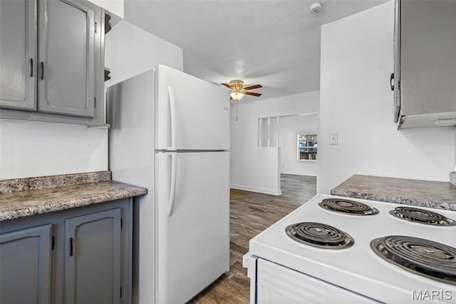 209 N Washington St, Desloge, MO 63601 - kitchen with white appliances, dark wood-type flooring, ceiling fan, gray cabinets, and baseboards