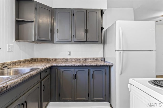 209 N Washington St, Desloge, MO 63601 - kitchen with open shelves, white appliances, and gray cabinets