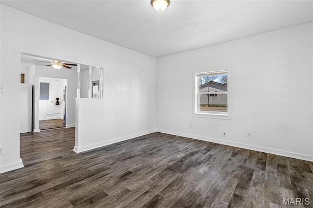 209 N Washington St, Desloge, MO 63601 - empty room featuring dark wood-style flooring, a ceiling fan, and baseboards