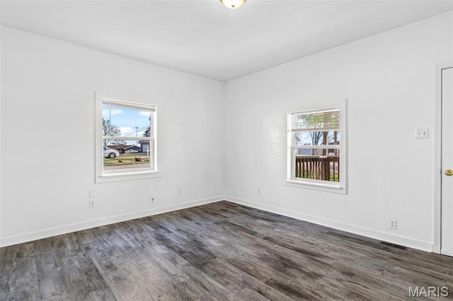209 N Washington St, Desloge, MO 63601 - spare room featuring dark wood-style floors and baseboards