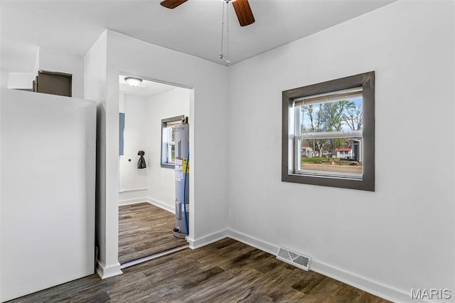 209 N Washington St, Desloge, MO 63601 - unfurnished bedroom featuring freestanding refrigerator, electric water heater, dark wood-style floors, and ensuite bathroom