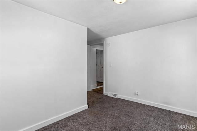 209 N Washington St, Desloge, MO 63601 - empty room with dark colored carpet and baseboards
