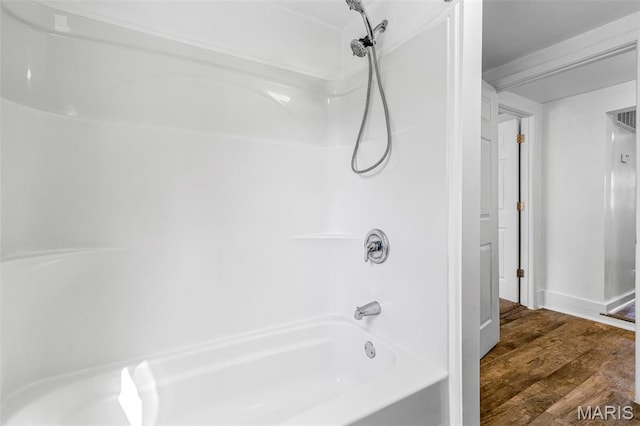 209 N Washington St, Desloge, MO 63601 - full bath featuring wood finished floors, bathing tub / shower combination, and baseboards