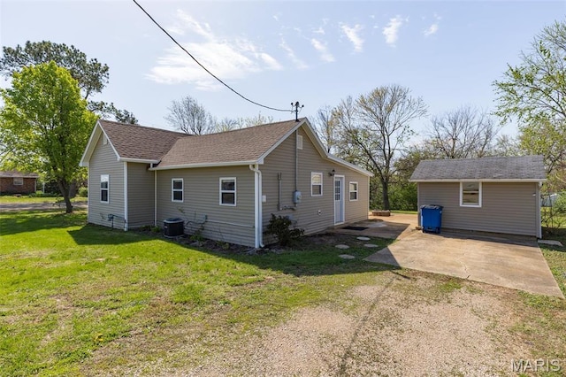 209 N Washington St, Desloge, MO 63601 - rear view of property with a yard, central AC unit, a shingled roof, a patio, and dirt driveway