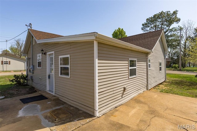 209 N Washington St, Desloge, MO 63601 - view of side of home with a shingled roof and a patio area