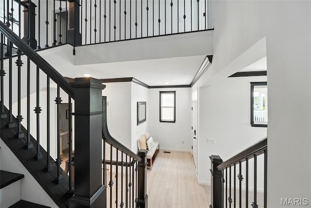 713 Alban Aly, Ofallon, MO 63368 - staircase featuring ornamental molding, baseboards, wood finished floors, a high ceiling, and recessed lighting