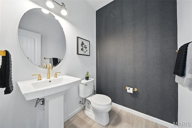 713 Alban Aly, Ofallon, MO 63368 - half bathroom featuring wood finished floors, toilet, and baseboards