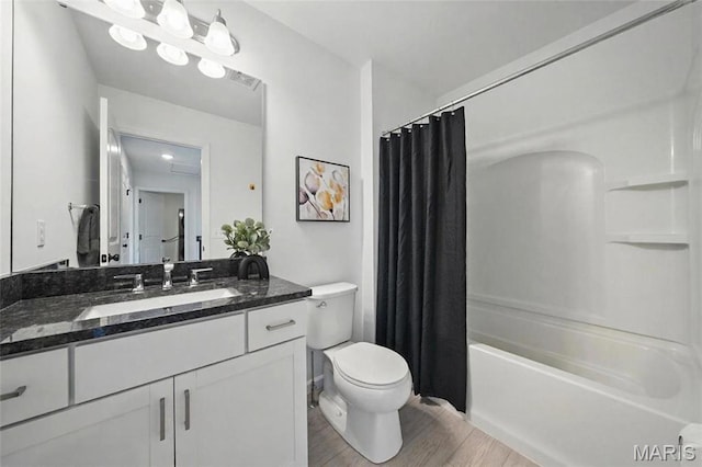 713 Alban Aly, Ofallon, MO 63368 - full bathroom featuring toilet, wood finished floors, vanity, and shower / bath combo with shower curtain