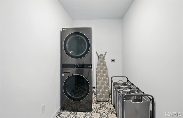 713 Alban Aly, Ofallon, MO 63368 - laundry room with estacked washer and dryer, baseboards, and tile patterned floors