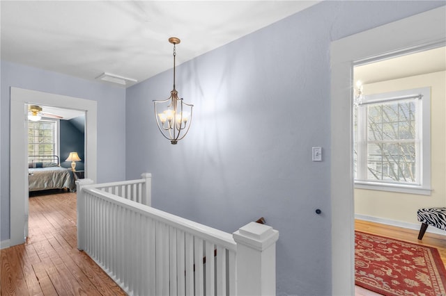 669 Park Ave, Sikeston, MO 63801 - hallway with an upstairs landing, hardwood / wood-style floors, and baseboards
