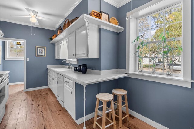 669 Park Ave, Sikeston, MO 63801 - kitchen with a sink, dishwashing machine, open shelves, ceiling fan, and white cabinets