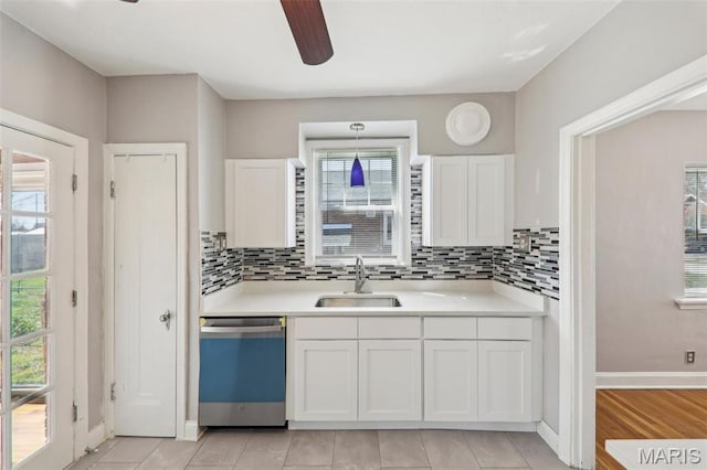 8724 Magdalen Ave, Saint Louis, MO 63144 - kitchen featuring a sink, dishwashing machine, white cabinetry, and light countertops