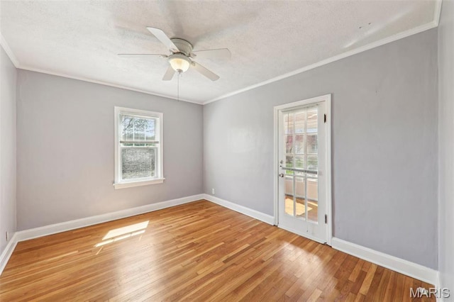 8724 Magdalen Ave, Saint Louis, MO 63144 - spare room featuring wood finished floors, a ceiling fan, a textured ceiling, baseboards, and crown molding