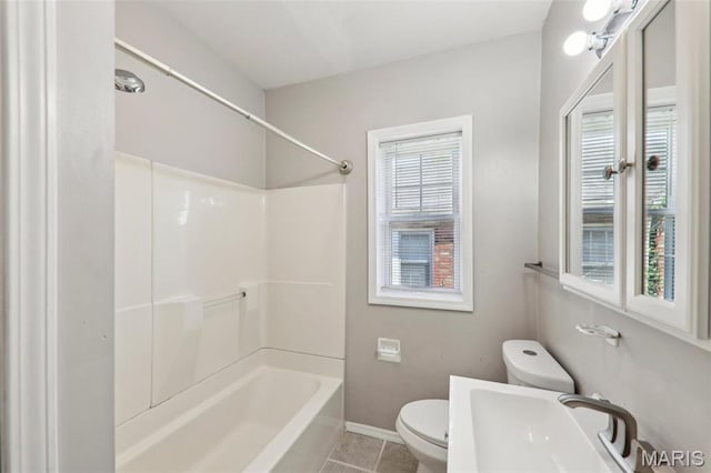 8724 Magdalen Ave, Saint Louis, MO 63144 - full bathroom featuring toilet, tile patterned flooring, a sink, baseboards, and shower / tub combination
