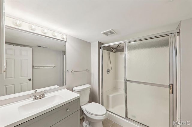 8724 Magdalen Ave, Saint Louis, MO 63144 - bathroom featuring a shower stall, toilet, vanity, and tile patterned flooring