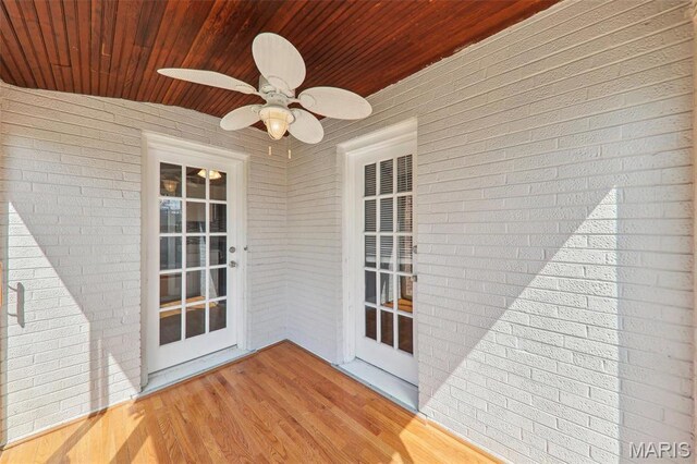 8724 Magdalen Ave, Saint Louis, MO 63144 - unfurnished sunroom with brick wall, wooden ceiling, and wood finished floors