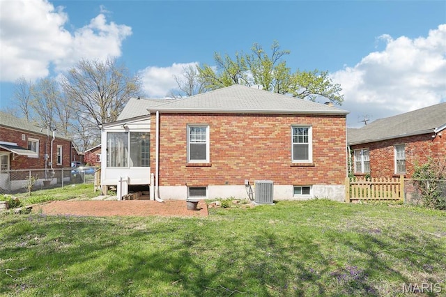 8724 Magdalen Ave, Saint Louis, MO 63144 - rear view of property featuring central air condition unit, a sunroom, and brick siding
