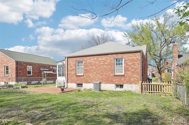 8724 Magdalen Ave, Saint Louis, MO 63144 - rear view of property featuring central AC, brick siding, and a shingled roof