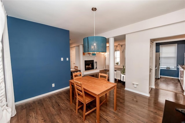 5507 Waterman Blvd Unit C, Saint Louis, MO 63112 - dining area with a fireplace with raised hearth, baseboards, and wood finished floors