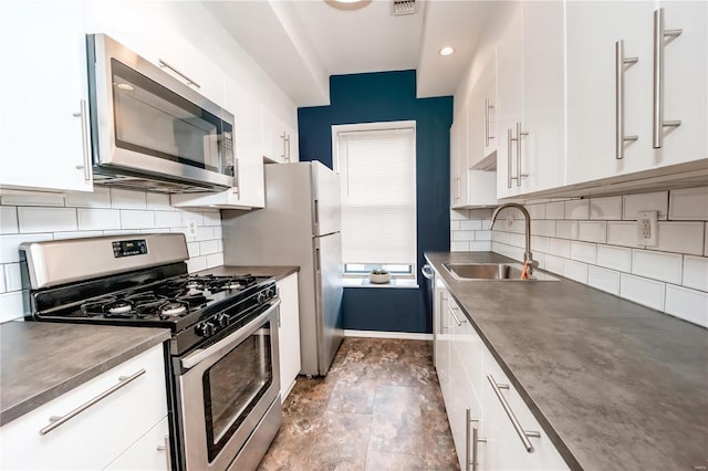 5507 Waterman Blvd Unit C, Saint Louis, MO 63112 - kitchen with stainless steel appliances, a sink, and white cabinets