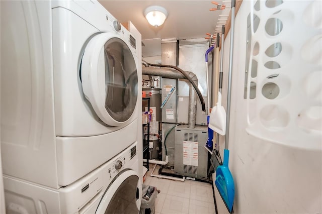 5507 Waterman Blvd Unit C, Saint Louis, MO 63112 - clothes washing area featuring stacked washing machine and dryer