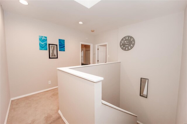 5507 Waterman Blvd Unit C, Saint Louis, MO 63112 - hallway with an upstairs landing, light carpet, recessed lighting, and baseboards