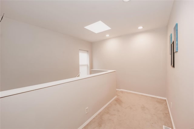 5507 Waterman Blvd Unit C, Saint Louis, MO 63112 - hall with a skylight, baseboards, recessed lighting, and light colored carpet
